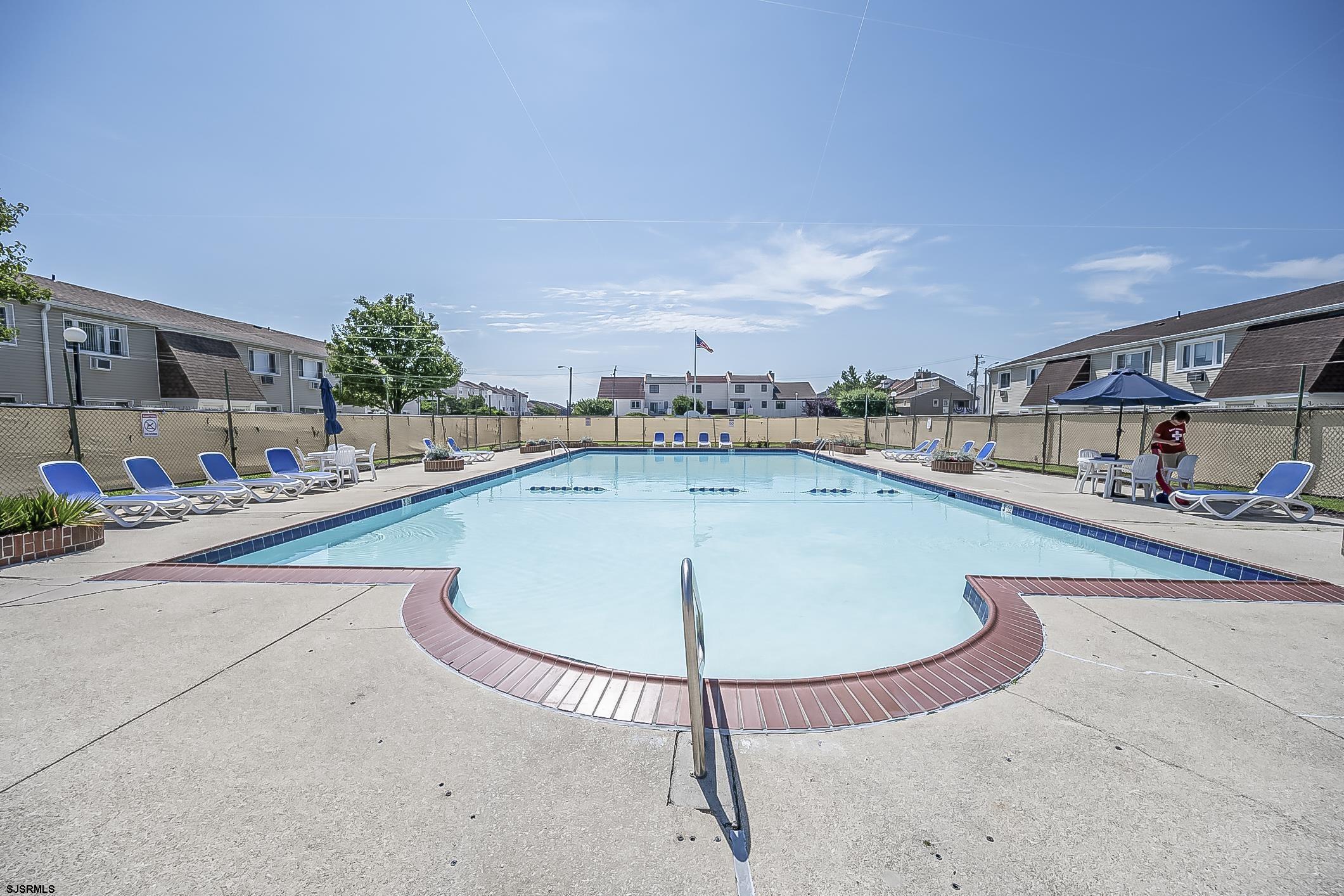 4901 Harbor Beach Boulevard, Unit Q3 Brigantine, NJ 08203 - Photo 16 of 19 a view of a swimming pool with a lounge chair