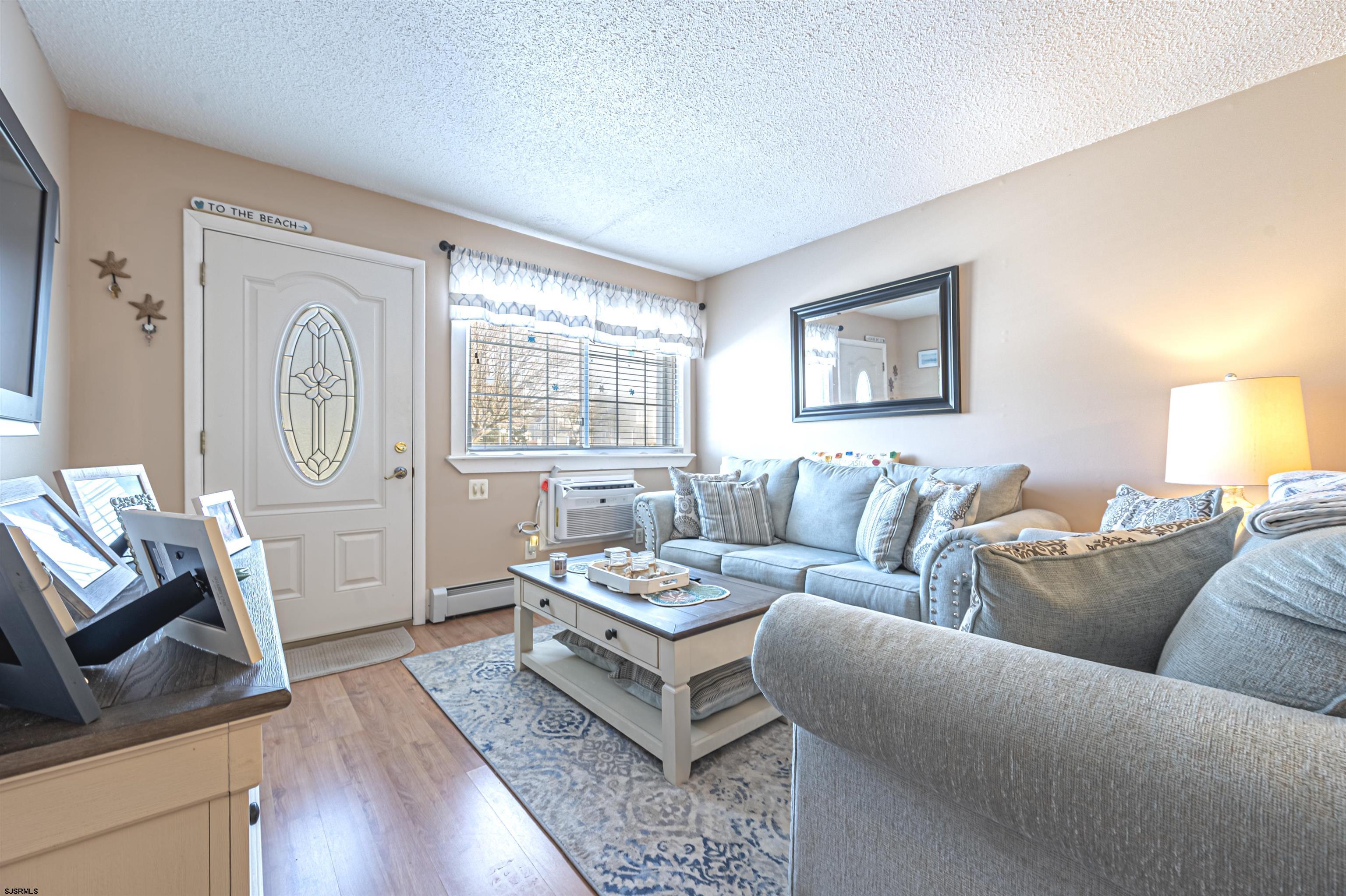 4901 Harbor Beach Boulevard, Unit Q3 Brigantine, NJ 08203 - Photo 3 of 19 a living room with furniture and a flat screen tv