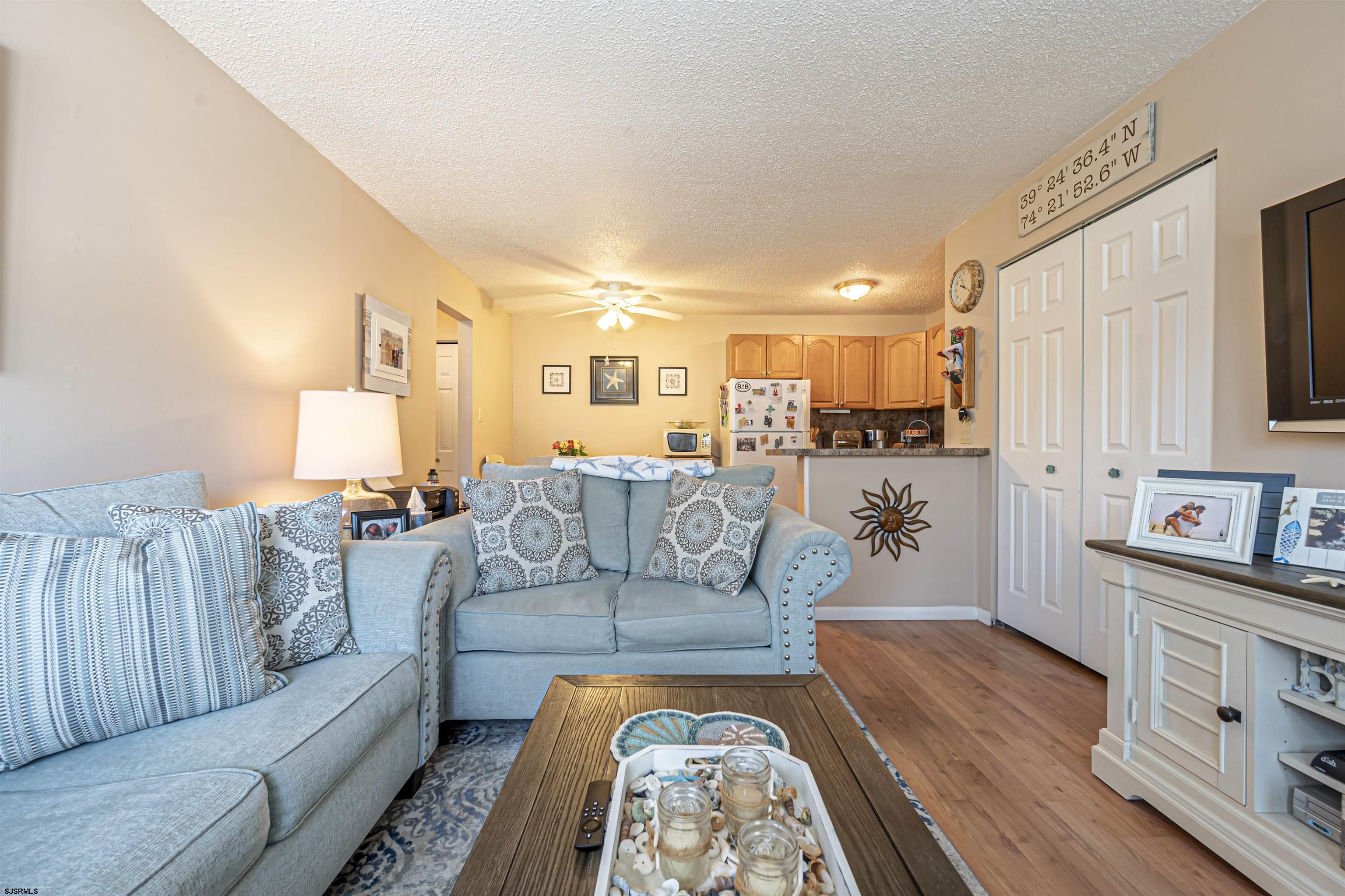 4901 Harbor Beach Boulevard, Unit Q3 Brigantine, NJ 08203 - Photo 4 of 19 a living room with furniture and a wooden floor