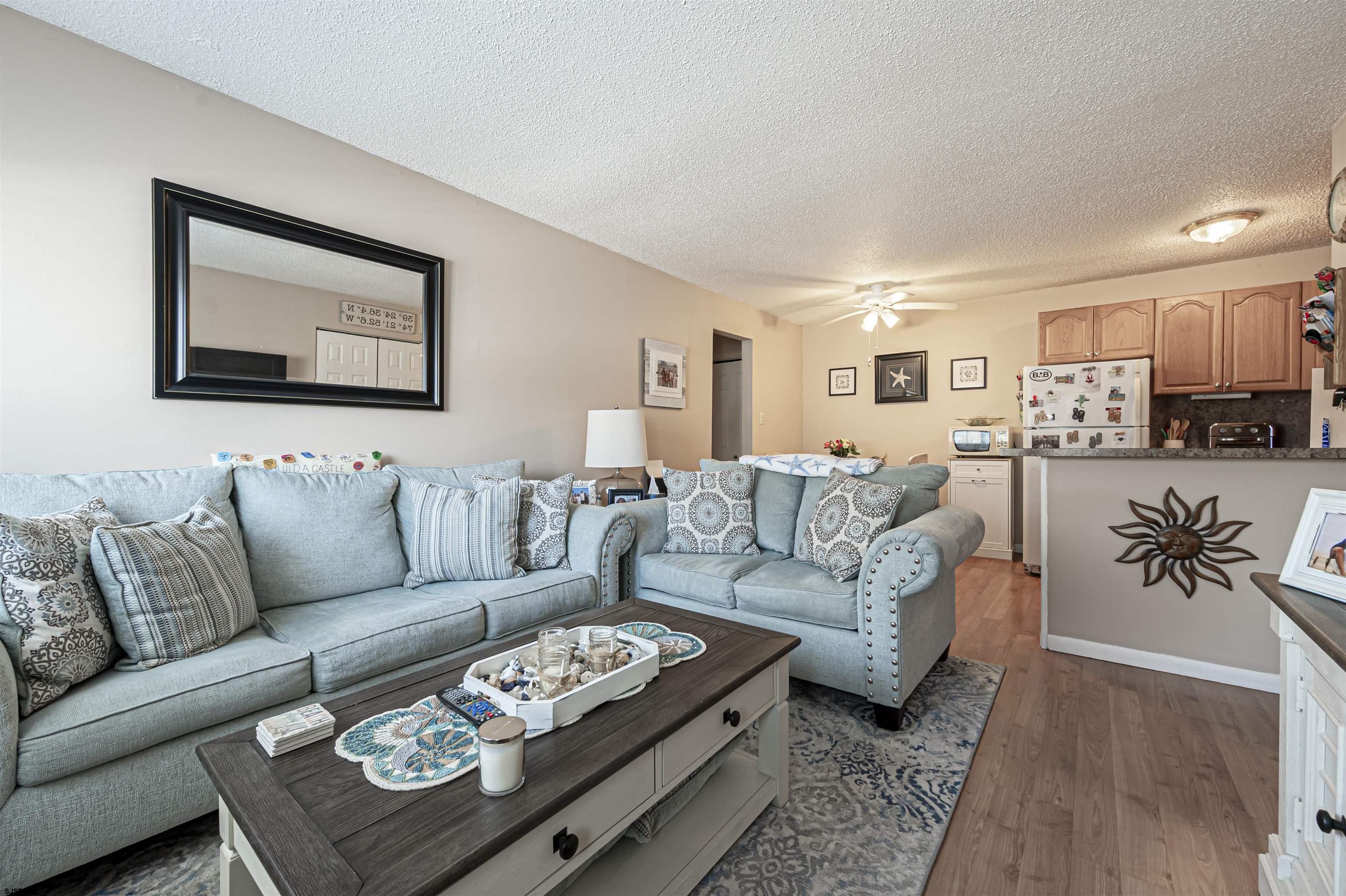 4901 Harbor Beach Boulevard, Unit Q3 Brigantine, NJ 08203 - Photo 5 of 19 a living room with furniture a couch and kitchen view