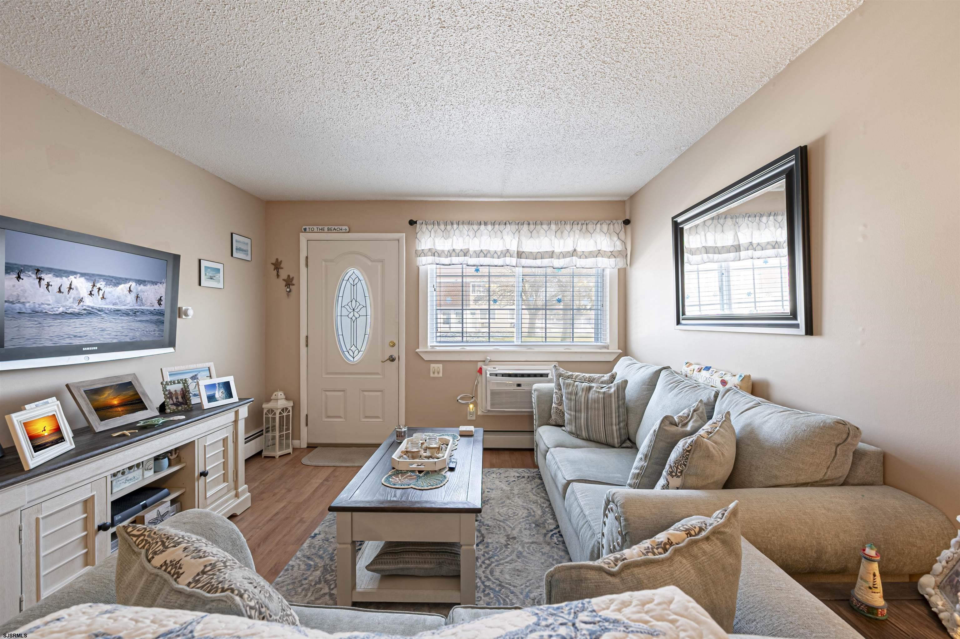 4901 Harbor Beach Boulevard, Unit Q3 Brigantine, NJ 08203 - Photo 6 of 19 a living room with furniture chess board and a window
