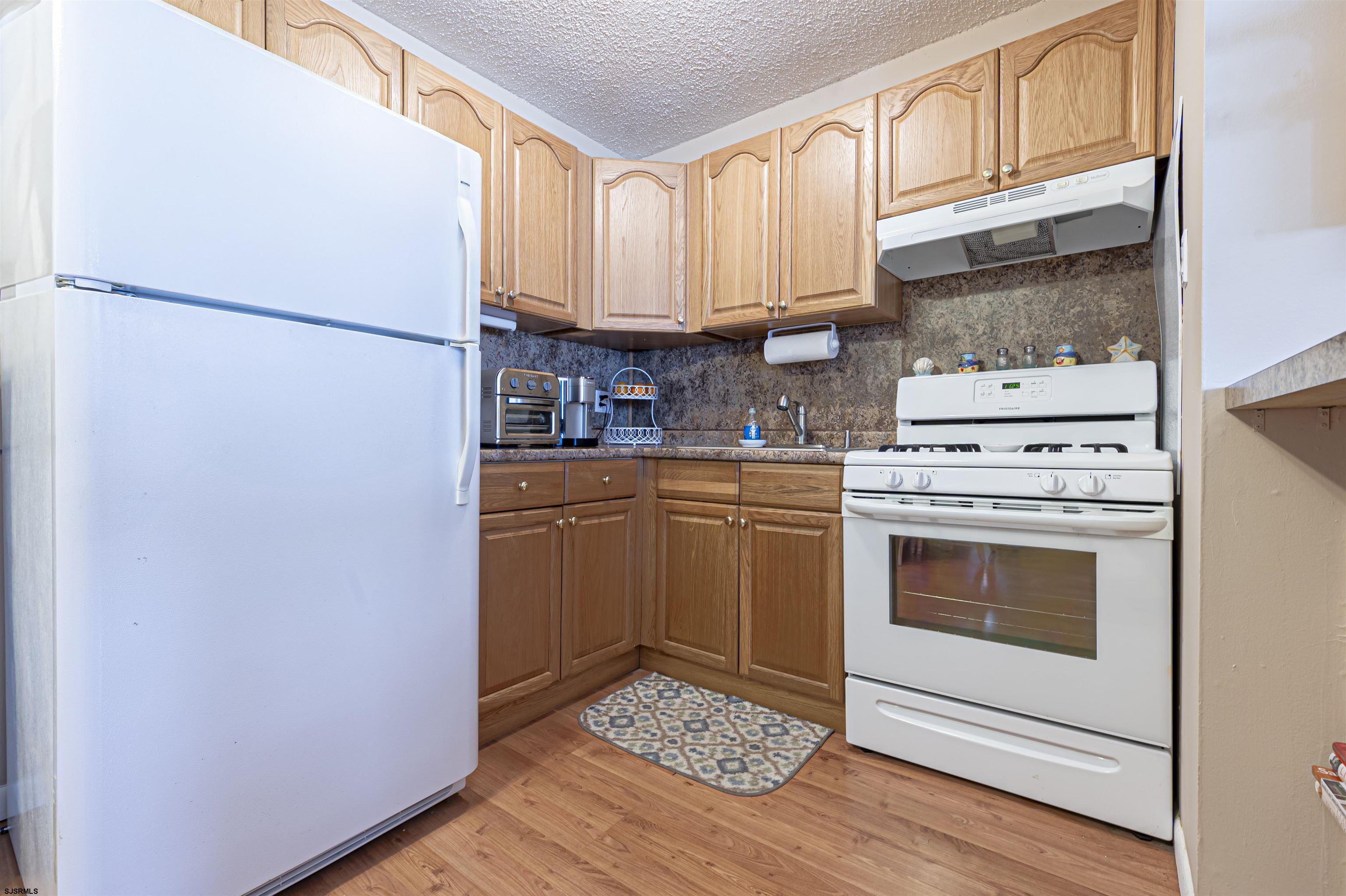 4901 Harbor Beach Boulevard, Unit Q3 Brigantine, NJ 08203 - Photo 9 of 19 a kitchen with stainless steel appliances a stove a refrigerator and cabinets