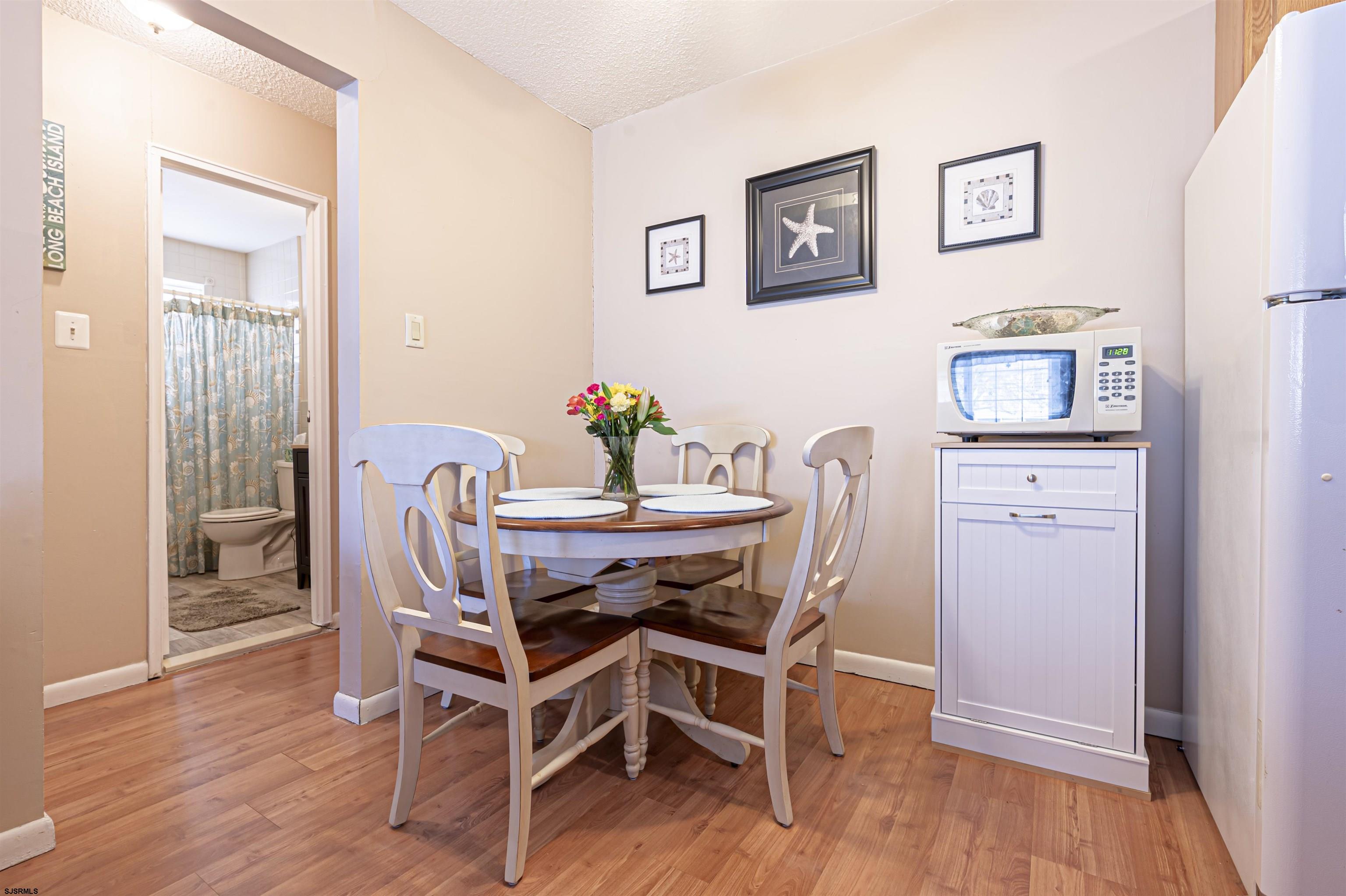 4901 Harbor Beach Boulevard, Unit Q3 Brigantine, NJ 08203 - Photo 10 of 19 a dining room with furniture and wooden floor