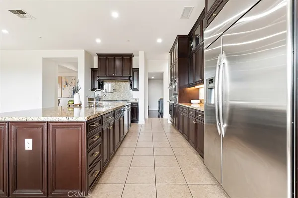 a kitchen with stainless steel appliances granite countertop a stove and a sink