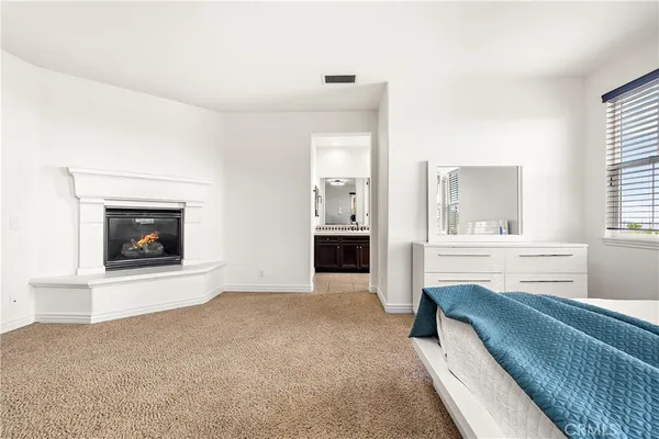 a view of a livingroom with an empty space and a fireplace
