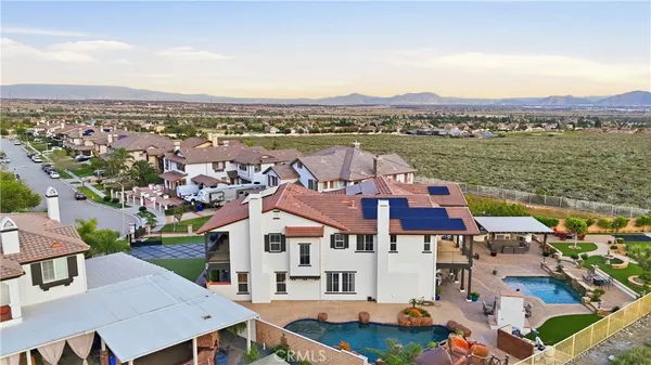 an aerial view of residential houses with outdoor space and ocean view