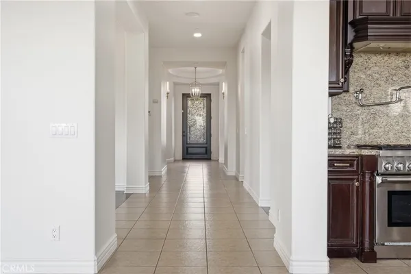 a hallway with a white walls and a painting on the wall