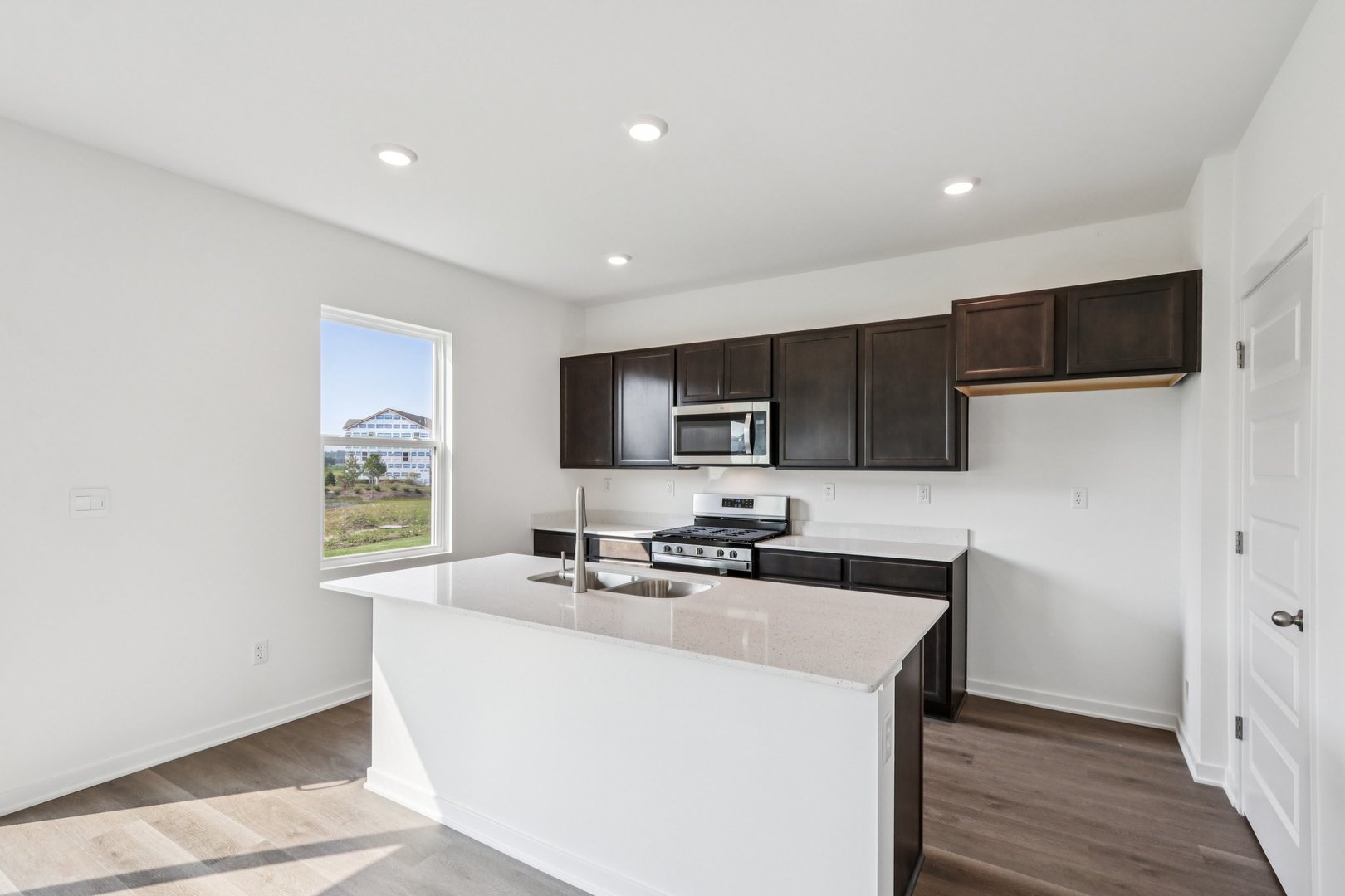 2561 Tahoe Lane Pingree Grove, IL 60140 - Photo 13 of 56 a kitchen with stainless steel appliances a sink a stove a microwave a refrigerator a counter top space and cabinets