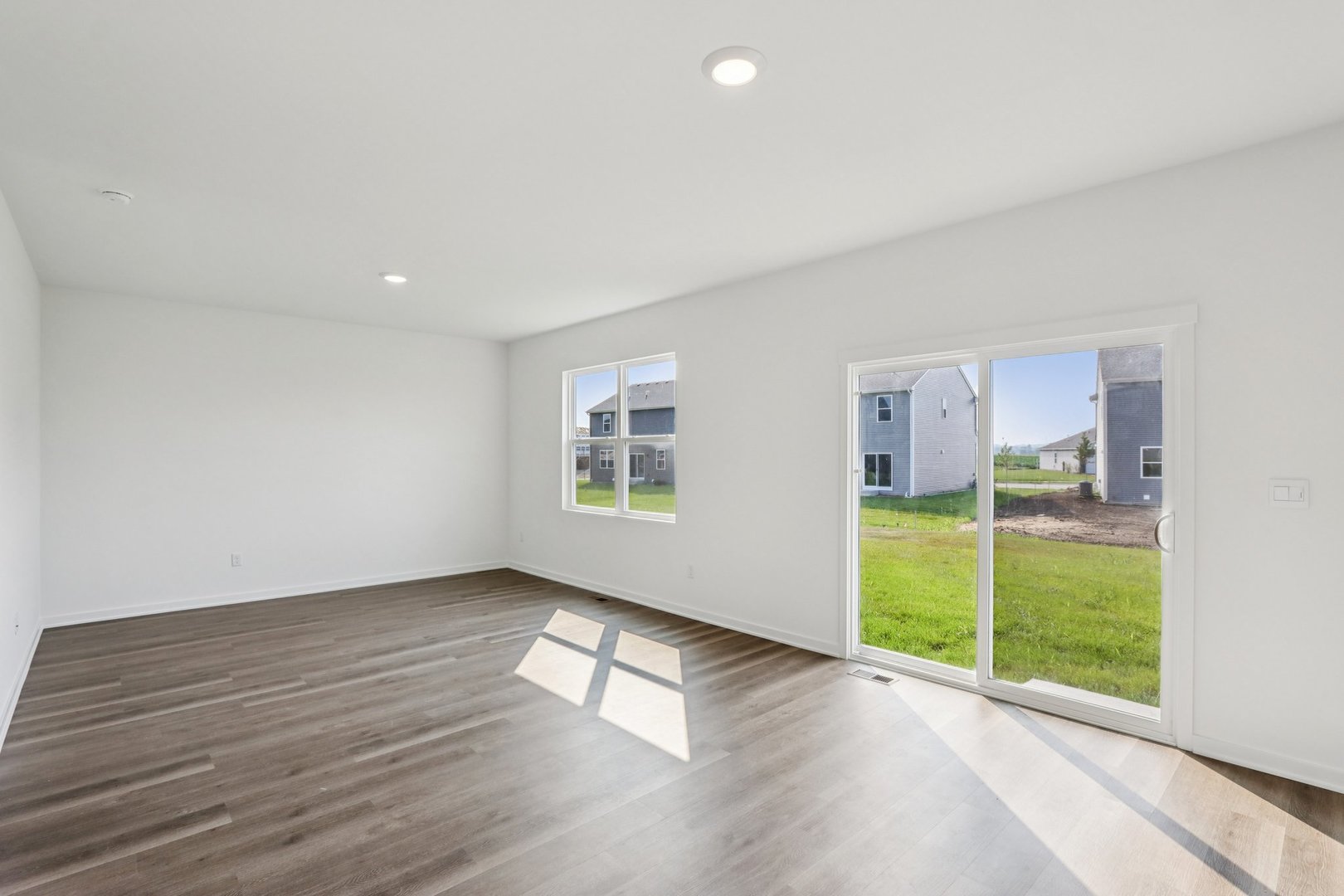 2561 Tahoe Lane Pingree Grove, IL 60140 - Photo 7 of 56 an empty room with wooden floor and windows