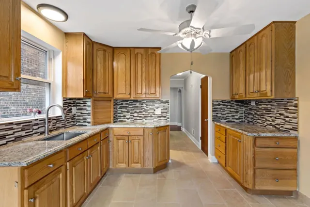 a kitchen with stainless steel appliances granite countertop a sink and cabinets