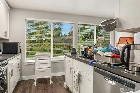 a kitchen with a sink appliances and a large window