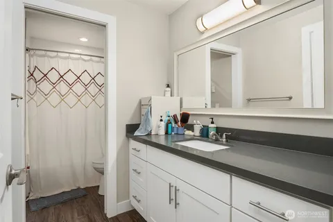 a bathroom with a double vanity sink and a mirror