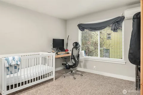a view of a bedroom with furniture and windows