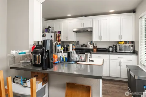 a kitchen with refrigerator and cabinets