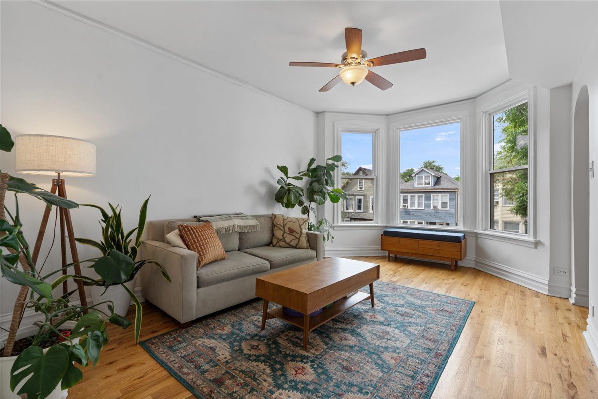 2735 North Ridgeway Avenue Chicago, IL 60647 - Photo 2 of 40 a living room with furniture ceiling fan and a rug