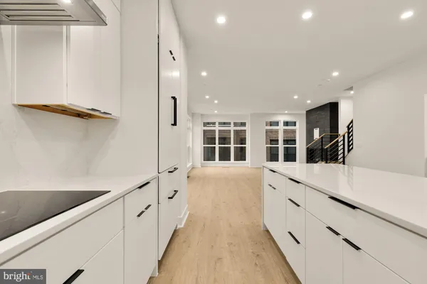 a kitchen with a sink stainless steel appliances and cabinets