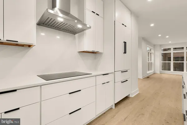 a kitchen with stainless steel appliances a sink and a refrigerator