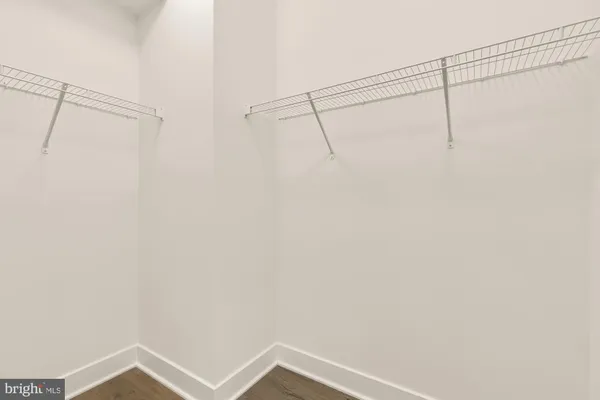 an empty room with wooden floor and sliding door