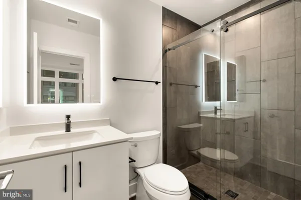 a bathroom with a shower toilet and sink