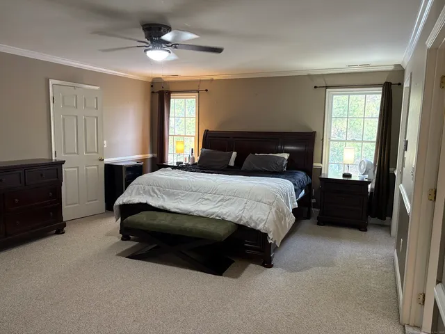 a bathroom with a tub sink shower and mirror