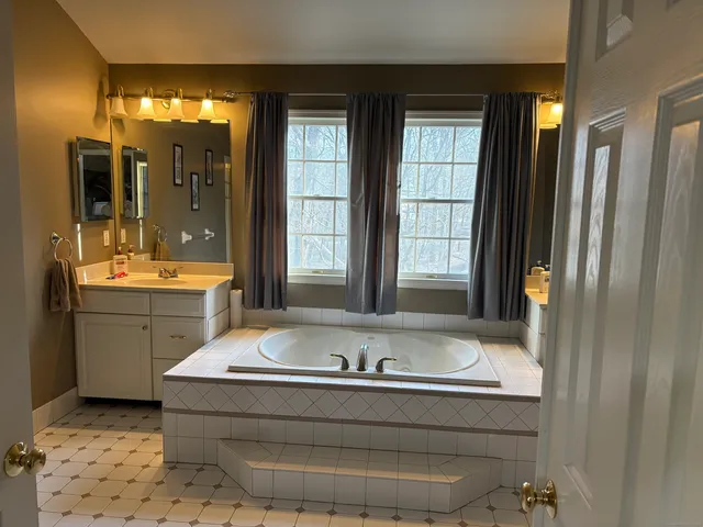 a bedroom with a bed and a mirror