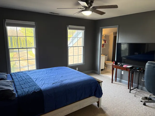 a bedroom with furniture and a window