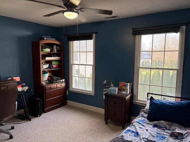 a bathroom with a sink a toilet and window