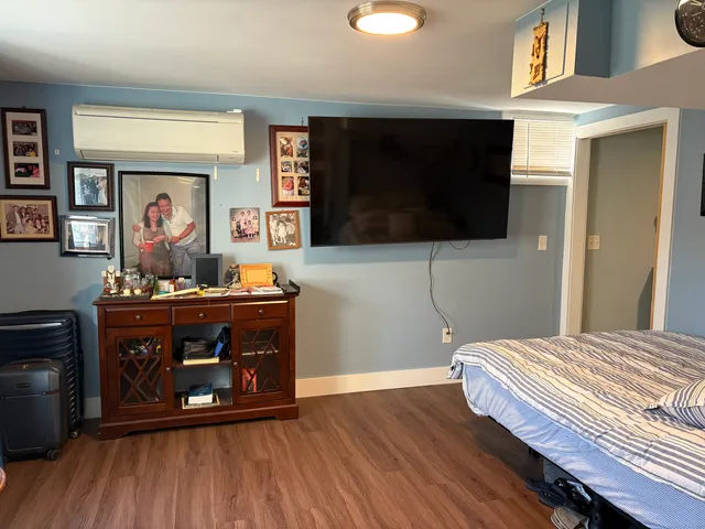 a view of a hallway with wooden floor and windows