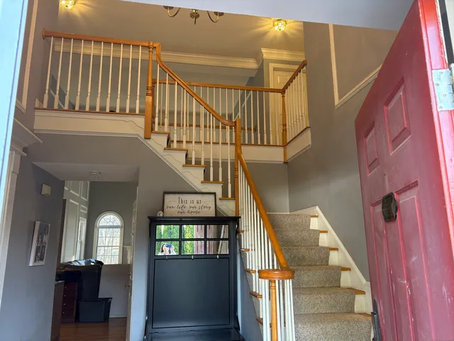 a view of entryway and hallway with wooden floor