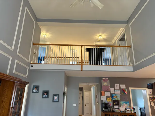 a living room with furniture a fireplace and a large window