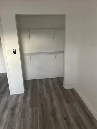 a view of a room with wooden floor