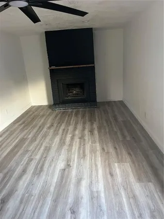 a living room with a fireplace and a flat screen tv