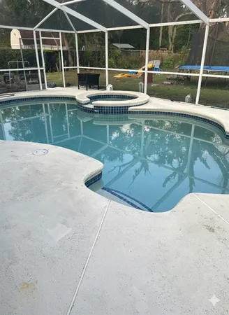 a view of a swimming pool with a yard