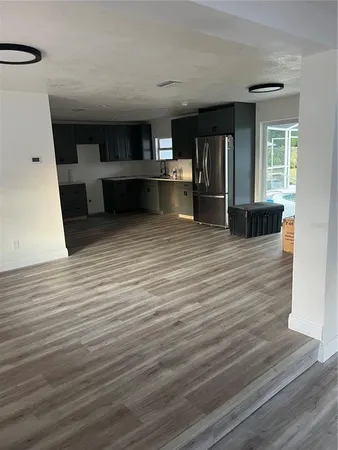 a view of a living room with wooden floor
