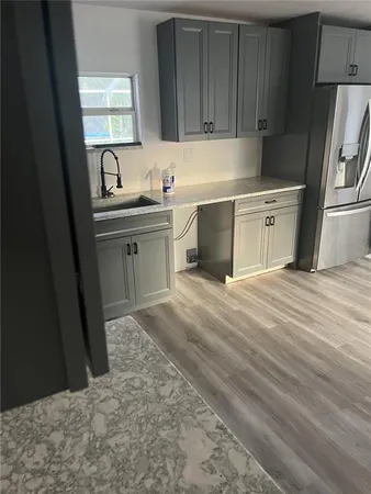 a kitchen with a sink cabinets and a refrigerator