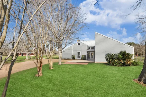 a view of a house with a yard and tree s