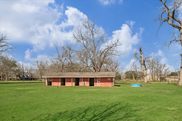 a front view of house with yard and trees