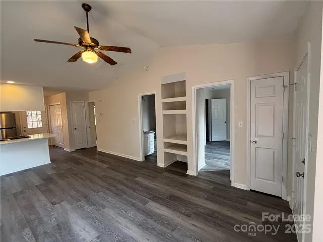 a view of empty room with wooden floor and window