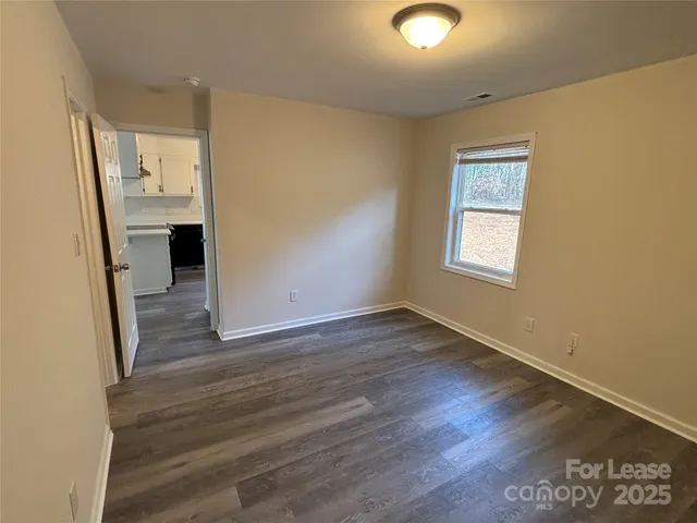 wooden floor in an empty room and a window