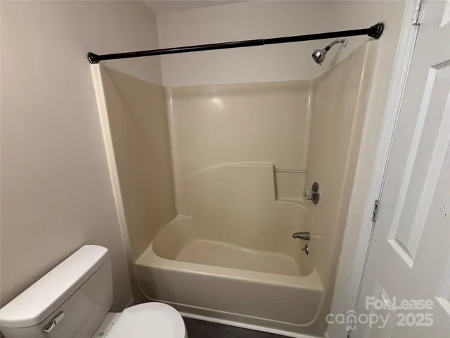 a bathroom with a shower and a toilet