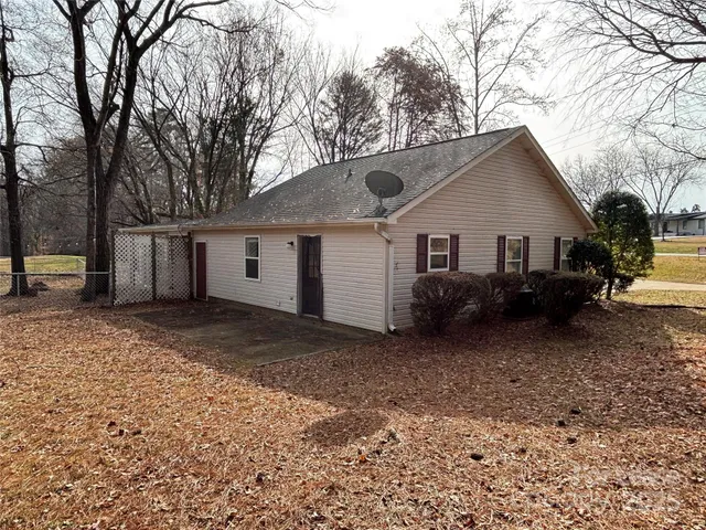 a view of a house with a yard covered in snow