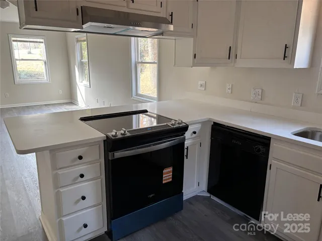 a kitchen with granite countertop a stove and a sink