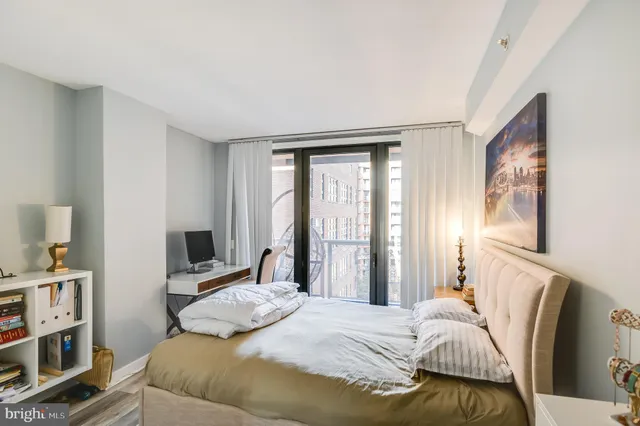 a bedroom with a bed and a window