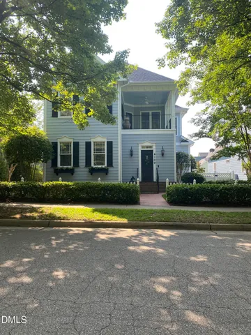 a bedroom with a large bed and ceiling fan