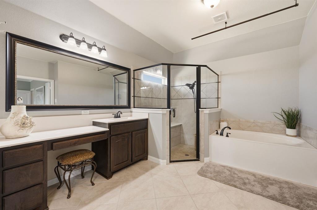 140 Heather Lane Decatur, TX 76234 - Photo 24 of 39 a spacious bathroom with a bathtub a sink and a mirror