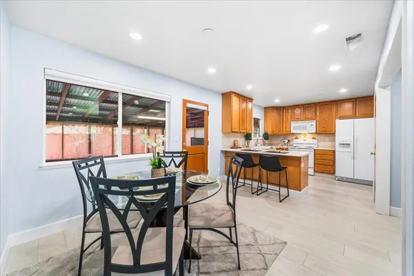 a view of a dining room with furniture and window