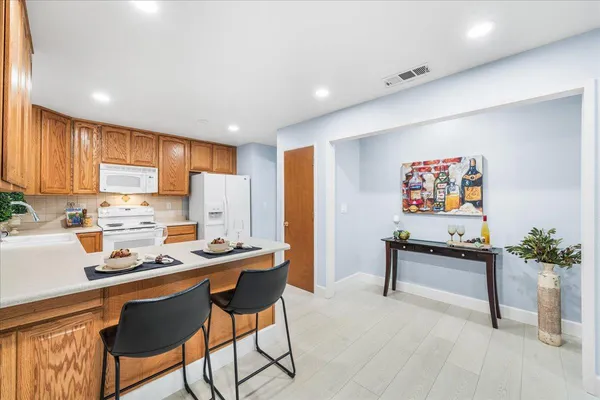a kitchen with stainless steel appliances kitchen island granite countertop a sink and cabinets