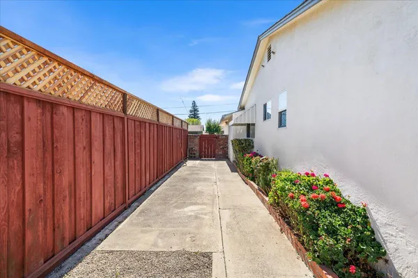 a view of a pathway gate with wooden fence