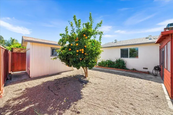 a view of a house with a yard and a garage