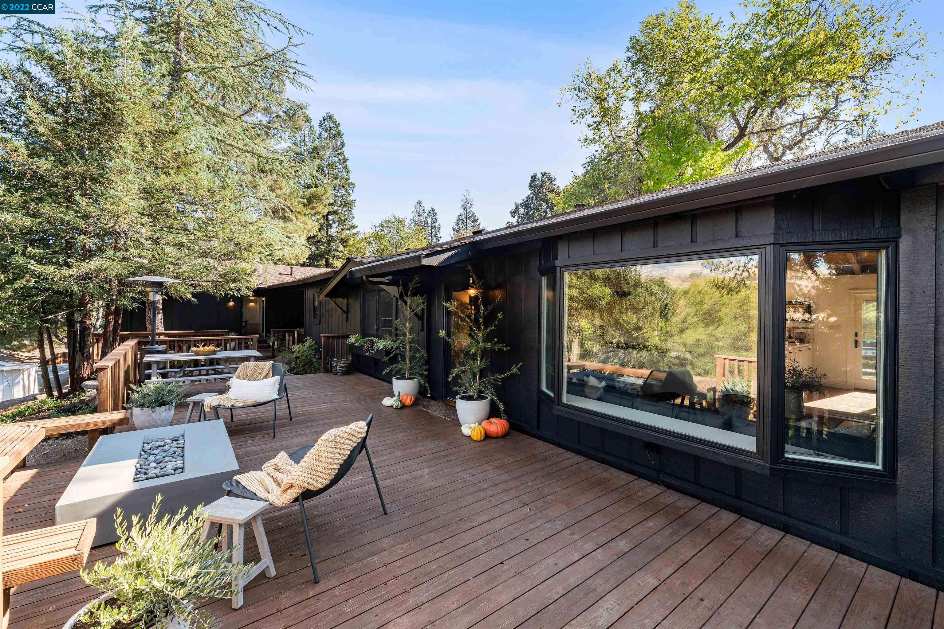 a view of a porch with furniture and a yard
